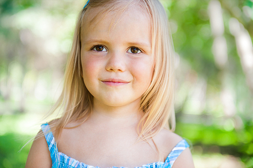 Cute little girl on the meadow in summer day