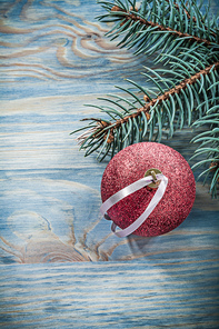 Pine branch red Christmas ball on wooden board celebrations concept.