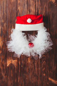 Christmas wreath like Santa head from lace and red bauble on the wooden door