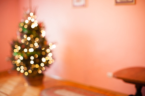 Blurred Christmas tree in basket in the empty room, copy space for text