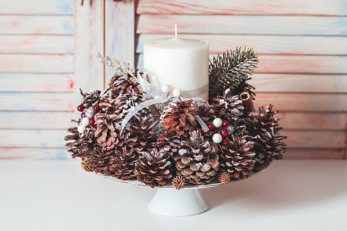 Christmas candlestick on the table, decoration with cones