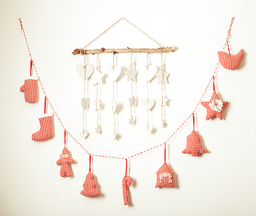 Handmade  white and red checkered christmas decorations hanging on a wall