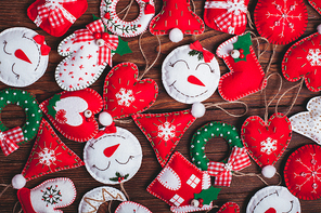 felt Christmas decorations on the wooden table as a background