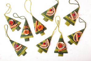 Christmas aromatic textile trees with dry orange and cinnamon sticks, closeup details