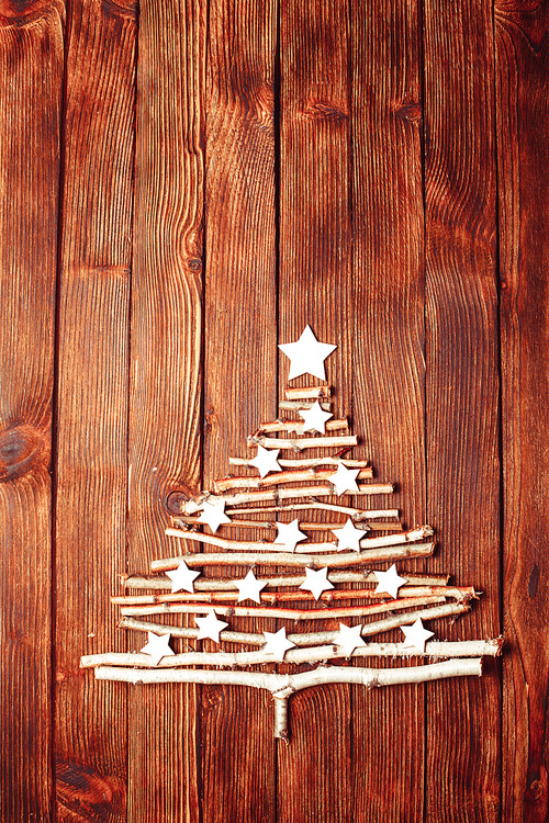 Birch branches and white stars in a shape of christmas tree