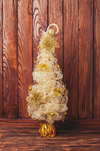 Golden Handmade Christmas tree over wooden background, copy space