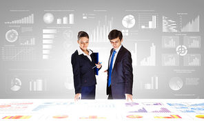 Businessman and businesswoman analyzing data information of market