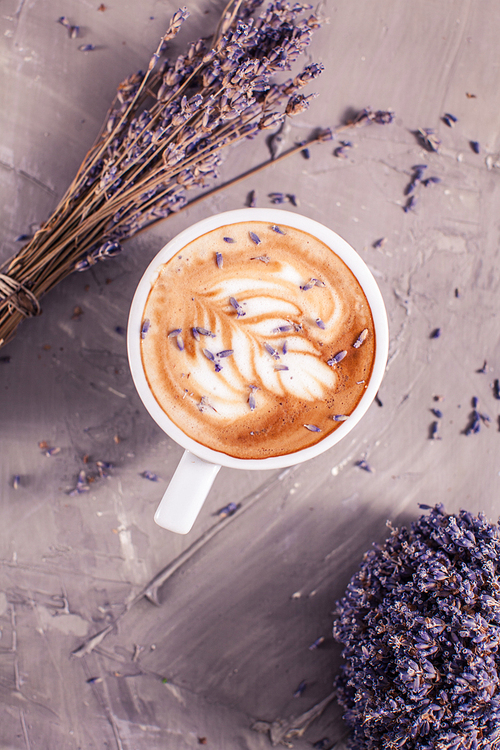 Close up of lavender cappuccino with figure cream in the white cup