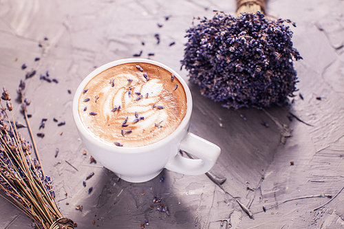 Close up of lavender cappuccino with figure cream in the white cup
