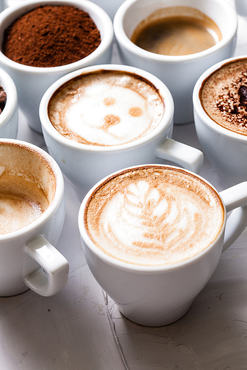 White cups of different stages of preparing cappuccino. Cofee lover concept still life