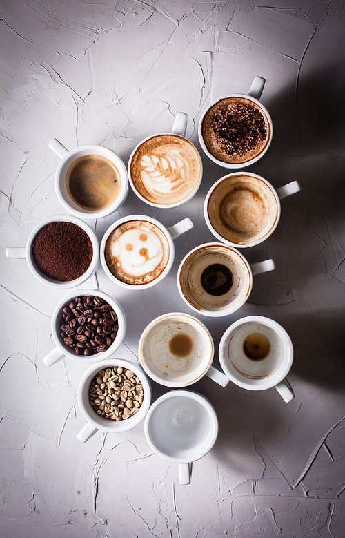 White cups of different stages of preparing cappuccino. Cofee lover concept still life