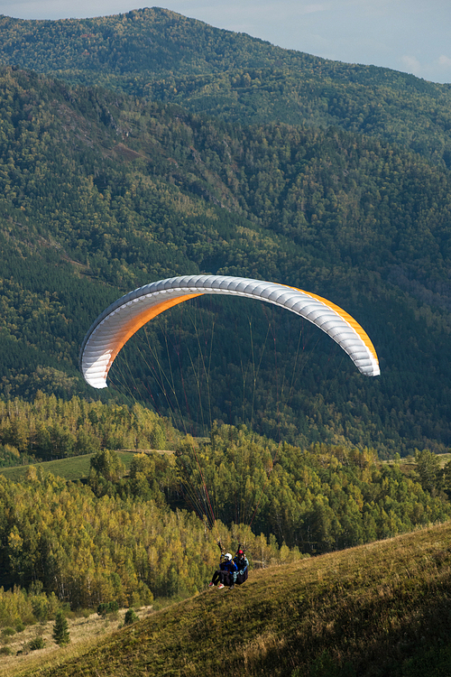 Paragliding in mountains. Para gliders in fight in the mountains, extreme sport activity.