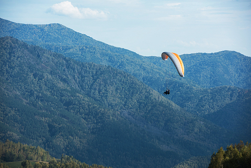 Paragliding in mountains. Para gliders in fight in the mountains, extreme sport activity.