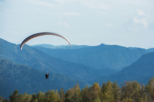 Paragliding in mountains. Para gliders in fight in the mountains, extreme sport activity.