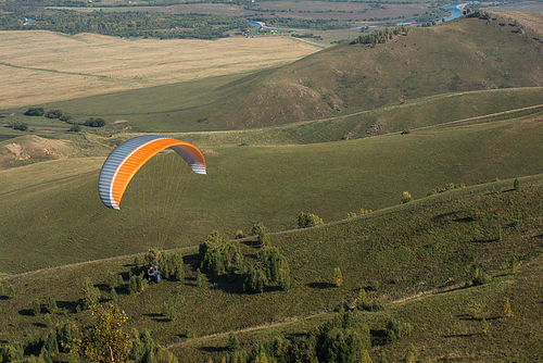 Paragliding in mountains. Para gliders in fight in the mountains, extreme sport activity.