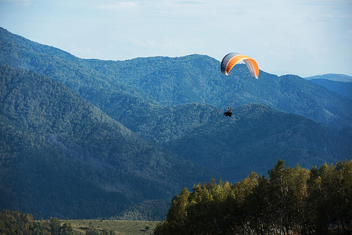 Paragliding in mountains. Para gliders in fight in the mountains, extreme sport activity.