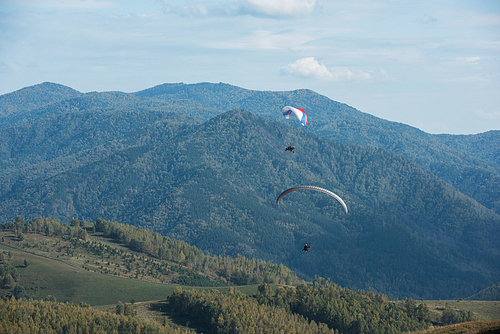 Paragliding in mountains. Para gliders in fight in the mountains, extreme sport activity.