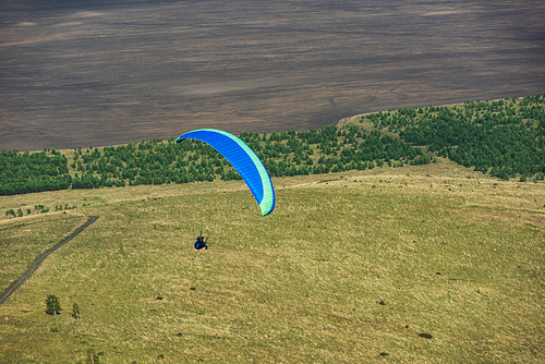 Paragliding in mountains. Para gliders in fight in the mountains, extreme sport activity.