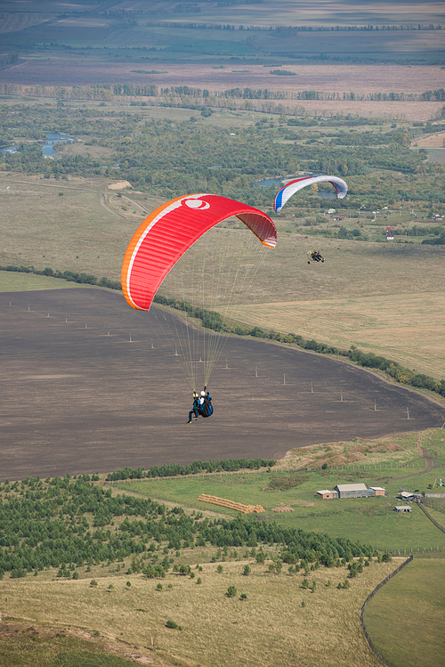 Paragliding in mountains. Para gliders in fight in the mountains, extreme sport activity.