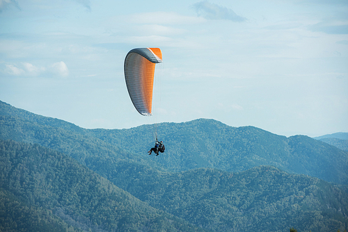 Paragliding in mountains. Para gliders in fight in the mountains, extreme sport activity.