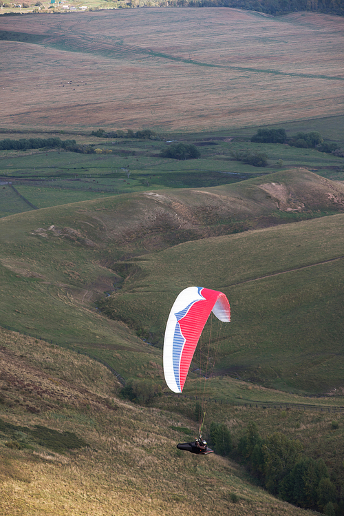 Paragliding in mountains. Para gliders in fight in the mountains, extreme sport activity.