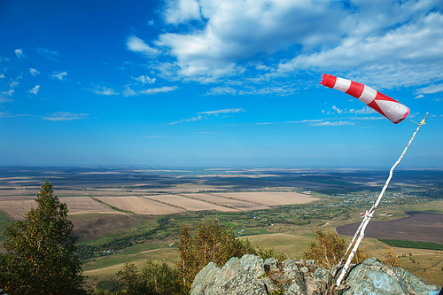 Flying windsock wind vane on mountine backgound, Check wind speed for paragliding in mountains