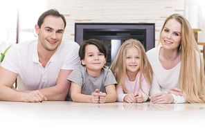 Portrait of four people family with children at home over chimney background