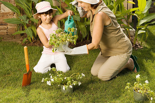 Girl and grandmother gardening