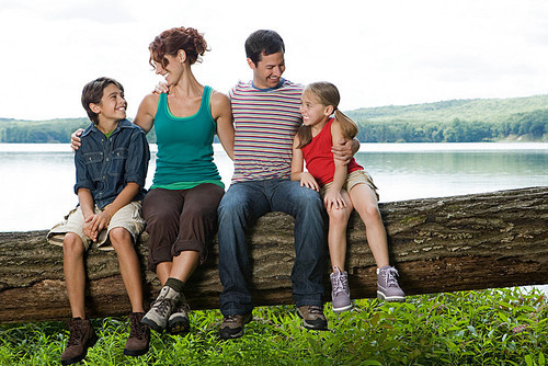 Family sitting on a log