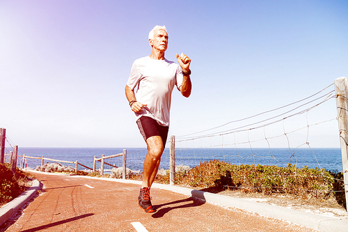 Healthy running man on beach