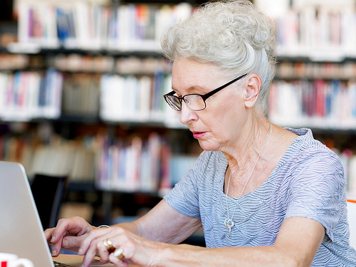 Elderly lady working with laptop