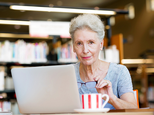 Elderly lady working with laptop