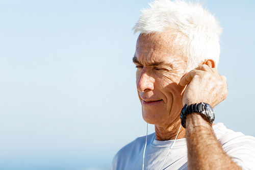 Sports and music. man getting ready for jogging and listening to the MP3 player