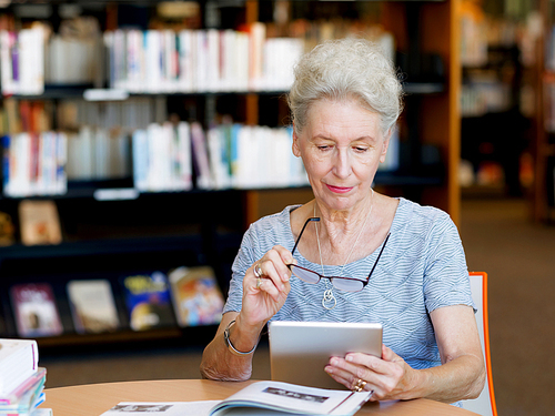 Elderly lady working with tablet