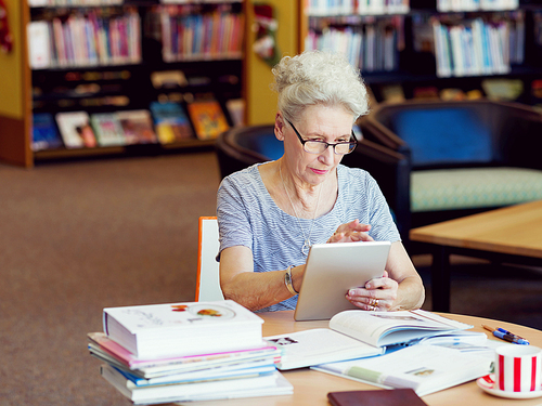 Elderly lady working with tablet