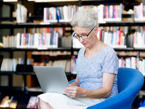 Elderly lady working with laptop