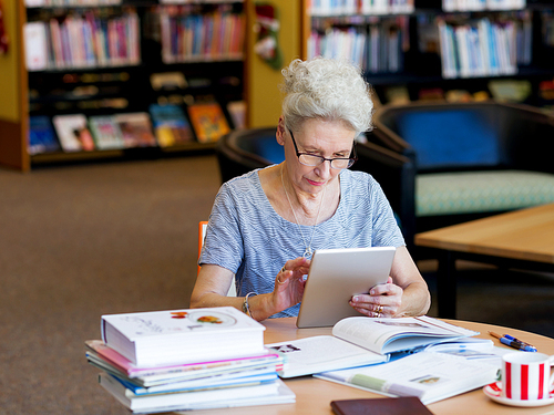 Elderly lady working with tablet