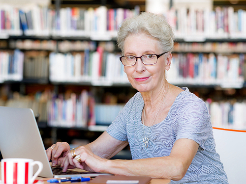 Elderly lady working with laptop