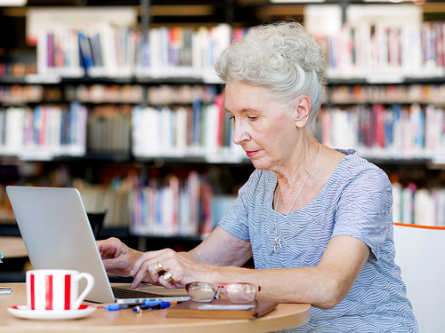 Elderly lady working with laptop