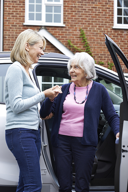 Female Neighbor Giving Senior Woman A Lift In Car