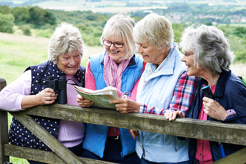 Group Of Senior Female Friends Hiking In Countryside