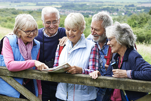 Group Of Senior Friends Hiking In Countryside