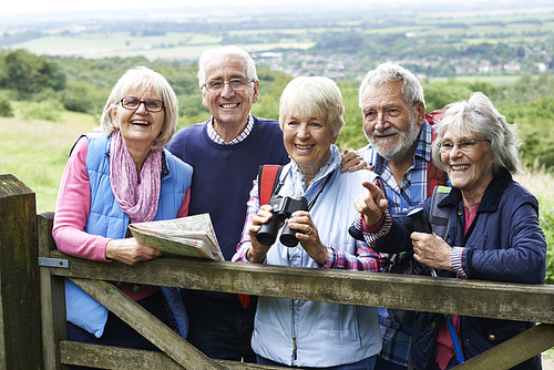 Group Of Senior Friends Hiking In Countryside