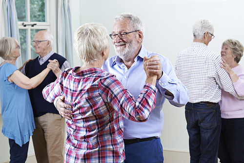 Group Of Seniors Enjoying Dancing Club Together