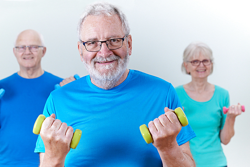 Group Of Seniors In Fitness Class Using Weights