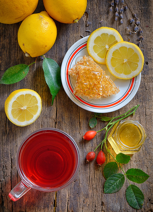 Tea with lemon and honey on wooden background