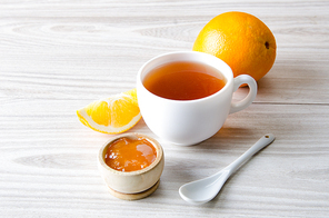 Cup of tea served with orange jam