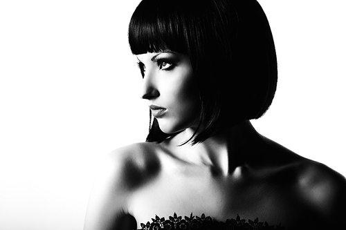 Fashion portrait of a young beautiful dark-haired woman. Black and white photo