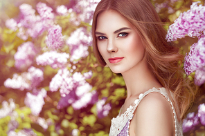 Beautiful Woman with Flowers of Lilac. Spring Blossom. Sexy Glamour Summer Beautiful Lady with Healthy and Beauty Hair