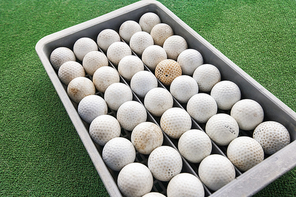 Rows of golf balls in tray on green; Koh Pha Ngan; Thailand